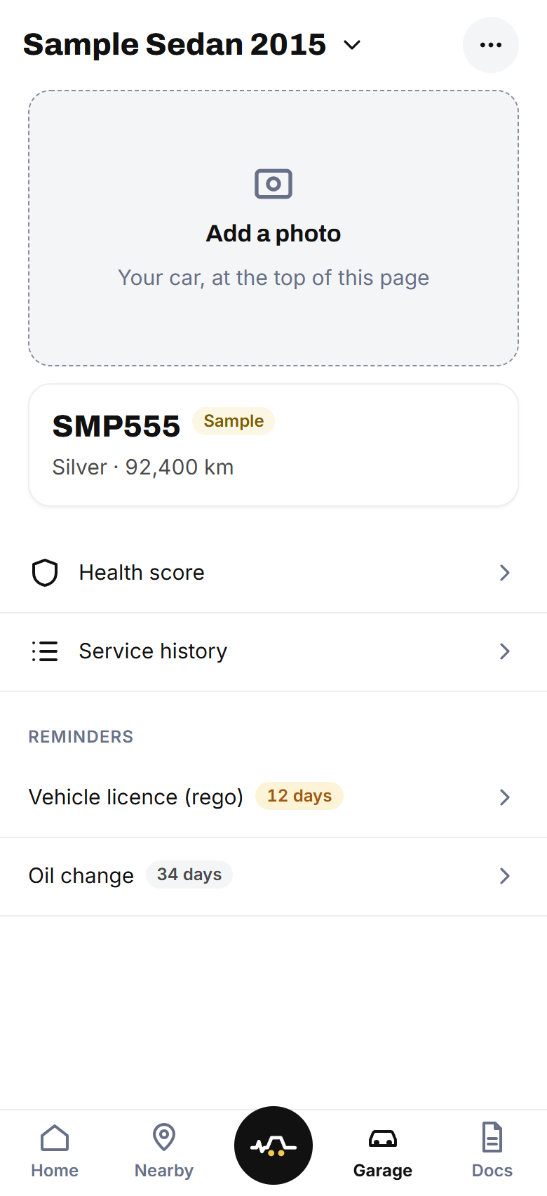The Garage screen: a sample car with its plate, colour and odometer, its health score and service history, and its reminders.